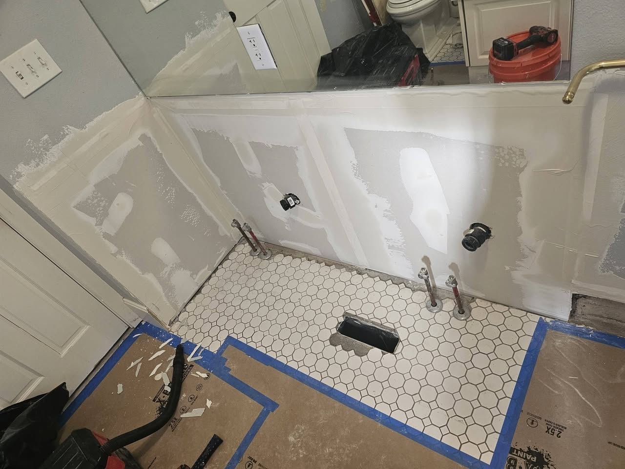 Bathroom in progress: new drywall, plumbing stubs and octagon tile