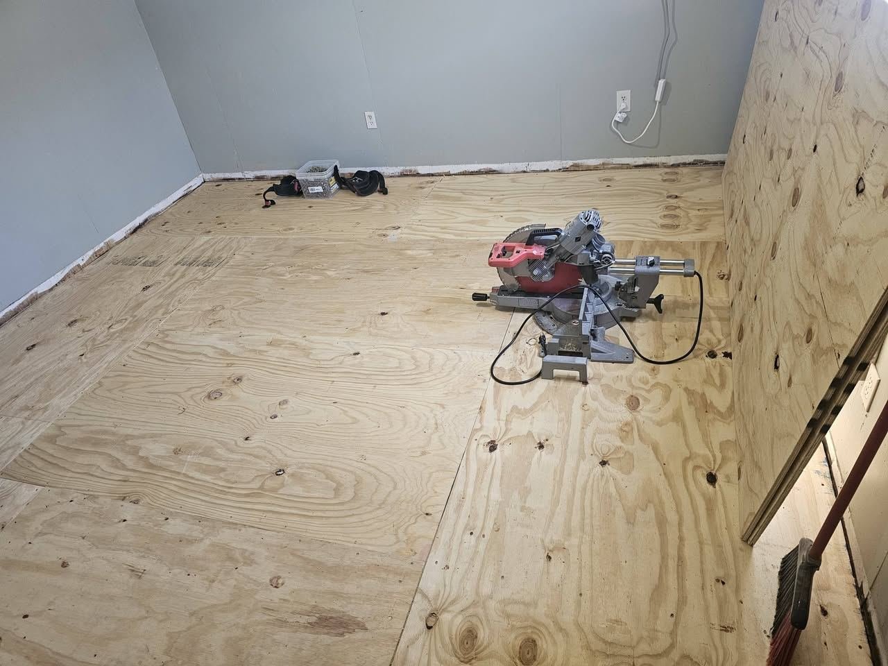 New plywood subfloor installed in an empty room